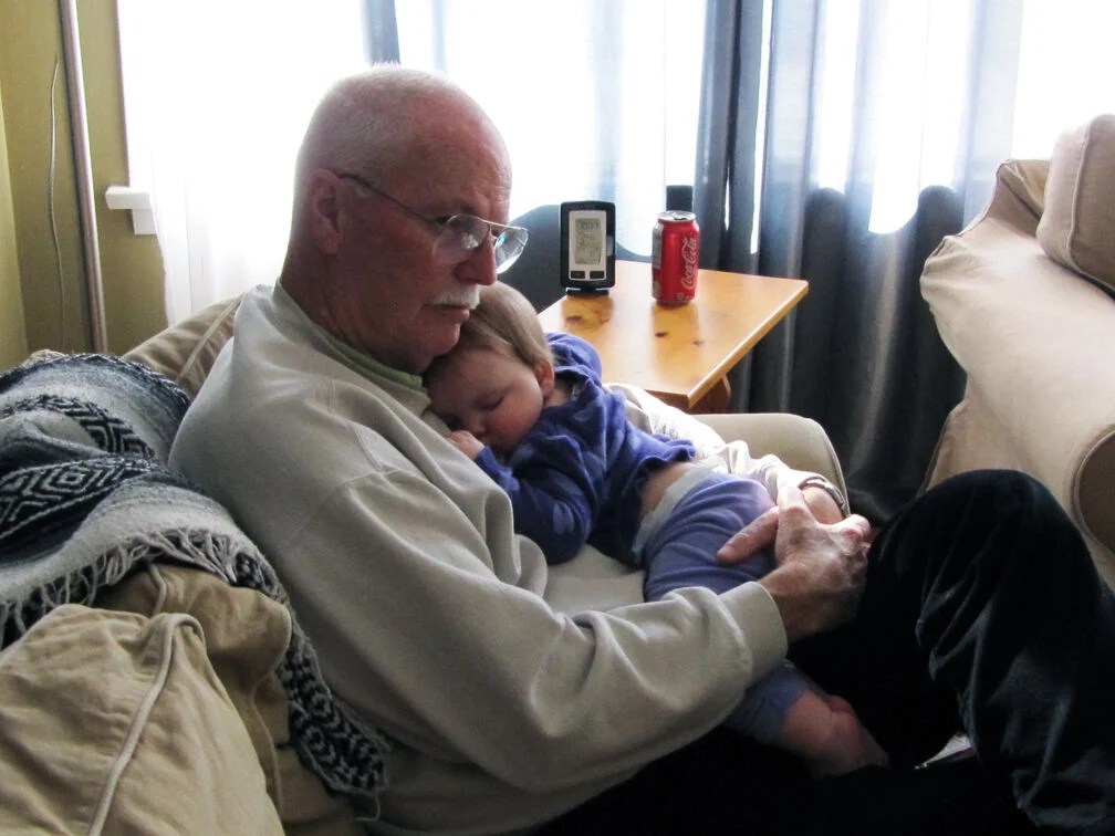 Barry holding his grandchild